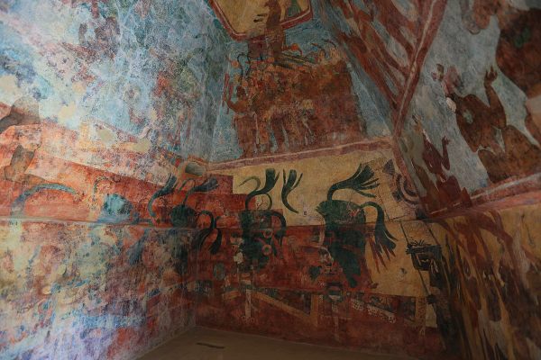 Floor-to-ceiling paintings cover the room.