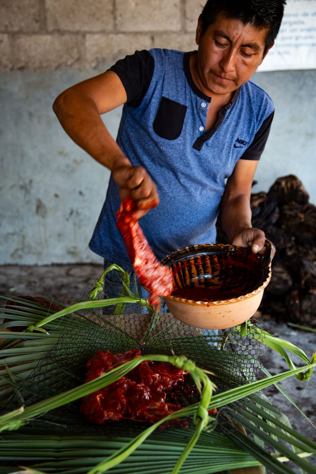 Salas lays the marinated venison on the chicken wire mesh that will hold it in place in the still.