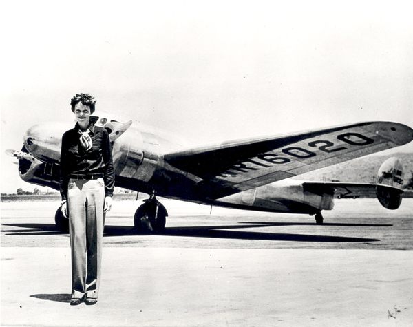 'a man standing in front of an airplane'