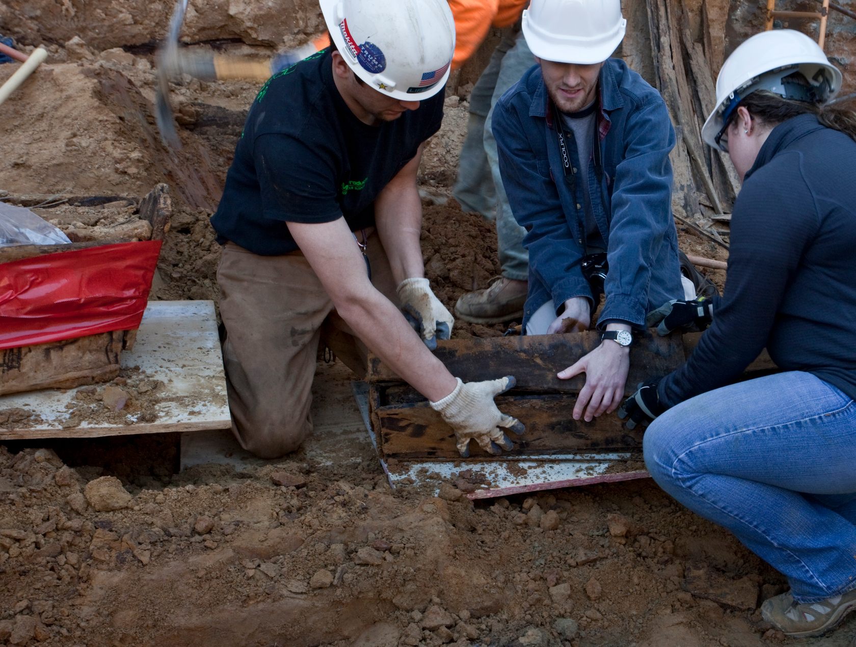 Contractors help unearth a coffin at the 218 Arch Street construction site in Philadelphia. 