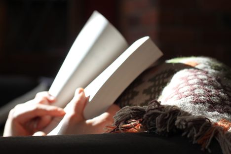 Essential winter survival gear: a book and a blanket. 