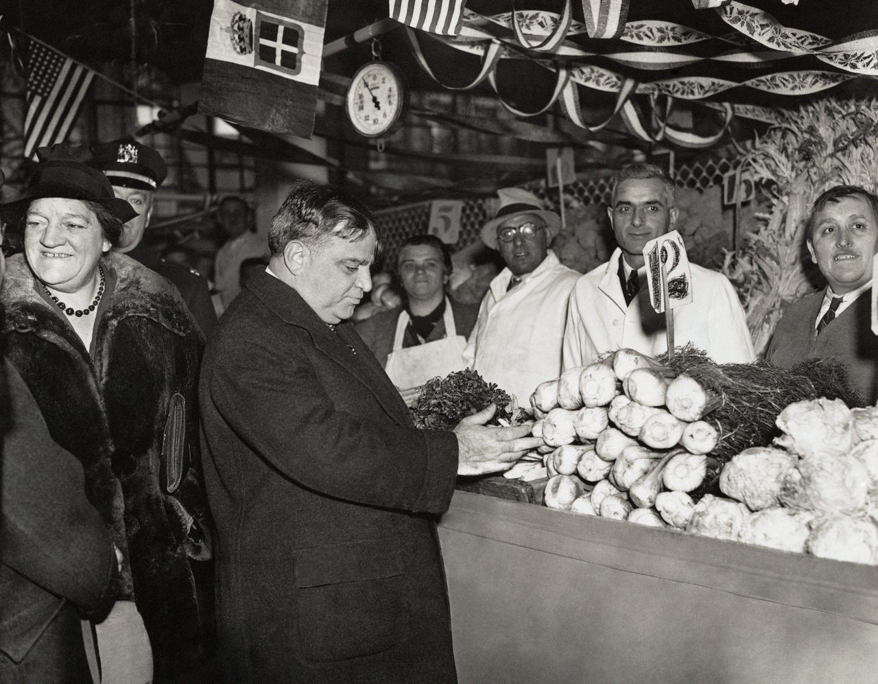 Mayor Fiorello LaGuardia examines produce at a stall several years after his artichoke war.
