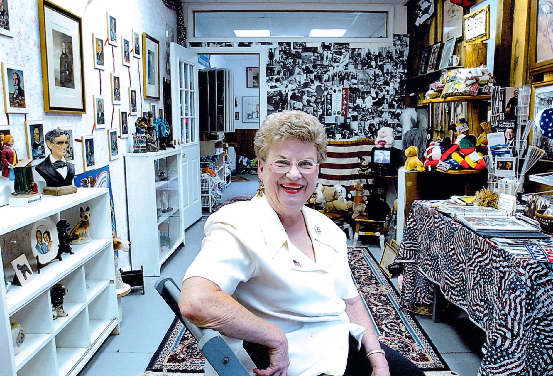 Claire McLean posing with her museum's collection, at their first location in Maryland.