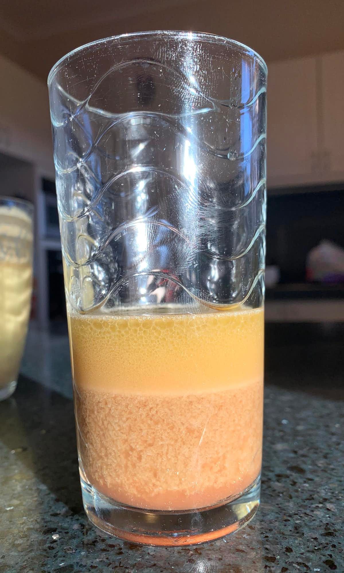 One of the experimental olive oil batches settling. The oil and vegetable water (lees or amurca) layers are easily distinguishable.