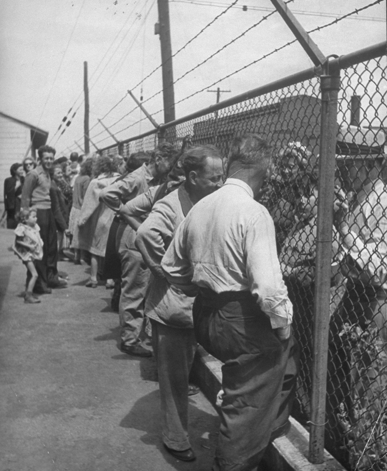 Jewish refugees behind the fence at Fort Ontario, a former army camp.