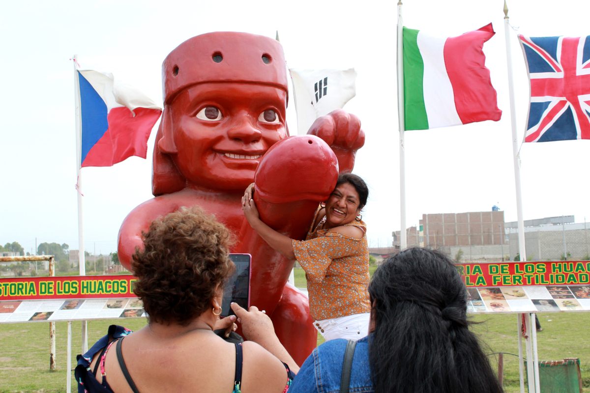 Local resident Graciela Zamora poses with a statue added to the site after the vandalism. Groups of friends, couples, and families with their pets have all flocked to this erotic landmark.
