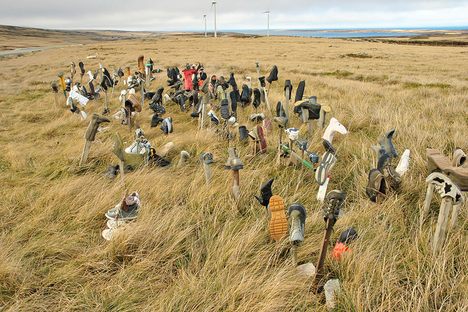 A field of single boots, shoes, and the occasional sandal