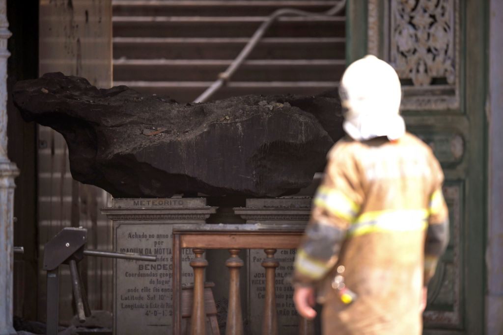 A meteorite is seen amid debris at Rio de Janeiro's treasured National Museum on September 3, 2018, a day after a massive fire ripped through the building. 