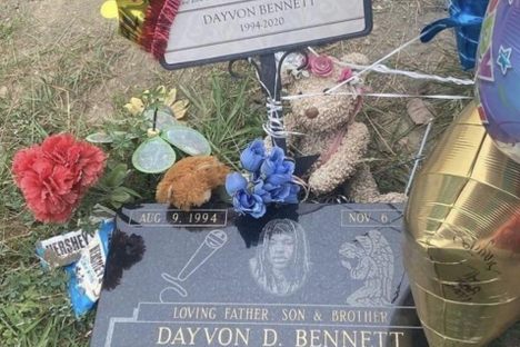 Balloons and stuffed animals from admirers cover King Von's headstone.