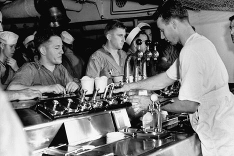 During WWII, sailors aboard a US Navy cruiser at sea flocked to the ice cream fountain.