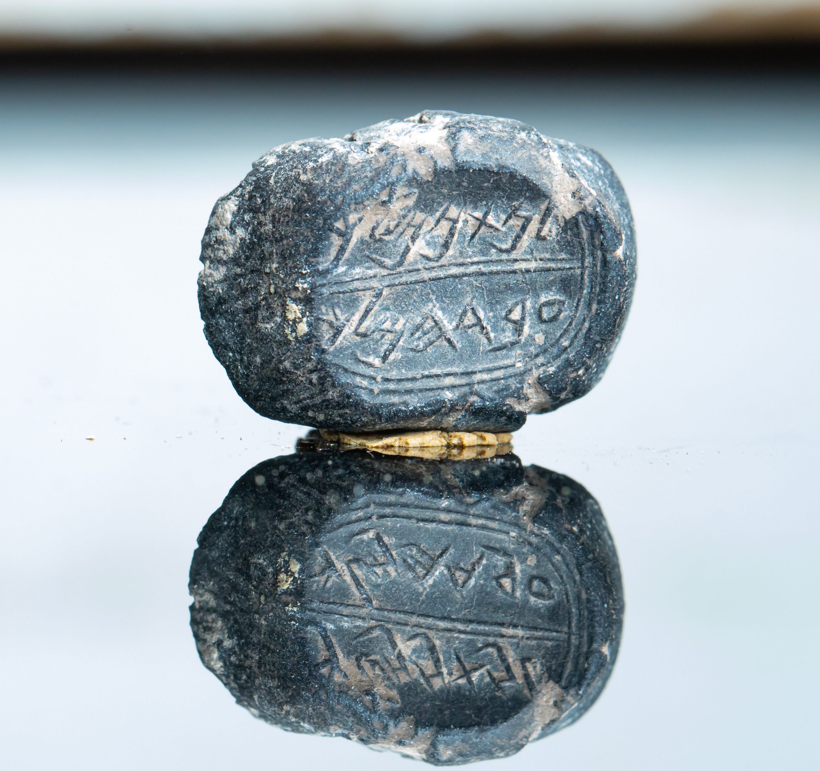 The text on the bulla reads, <i>"LeNathan-Melech Eved HaMelech."</i>