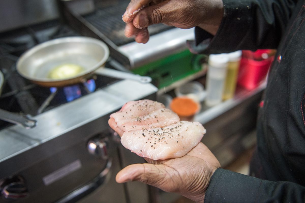 Chef David Thomas prepares blue catfish with madras curry.