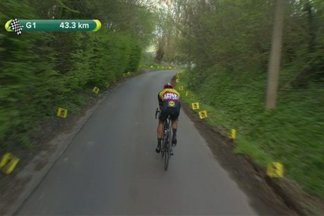 A contemporary Tour of Flanders rider zooms through a green landscape.