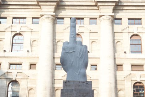 The statue with Palazzo Mezzanotte on the background