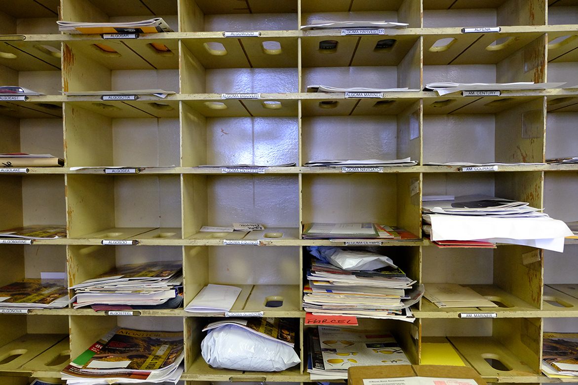 Pigeon holes in the J.W. Westcott’s mail room hold parcels for ships passing through the Detroit River. As technology has changed the way we communicate, the <em>Westcott</em> has carried less and less mail.