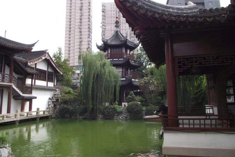 Modern Shanghai looms over the temple.