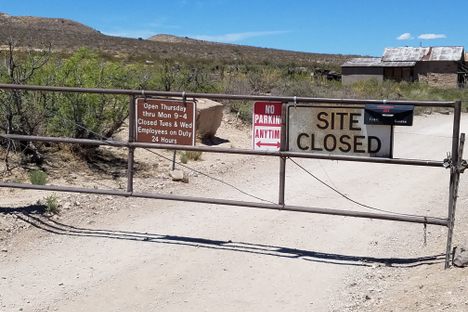 Gate prohibiting access to the site when closed. 