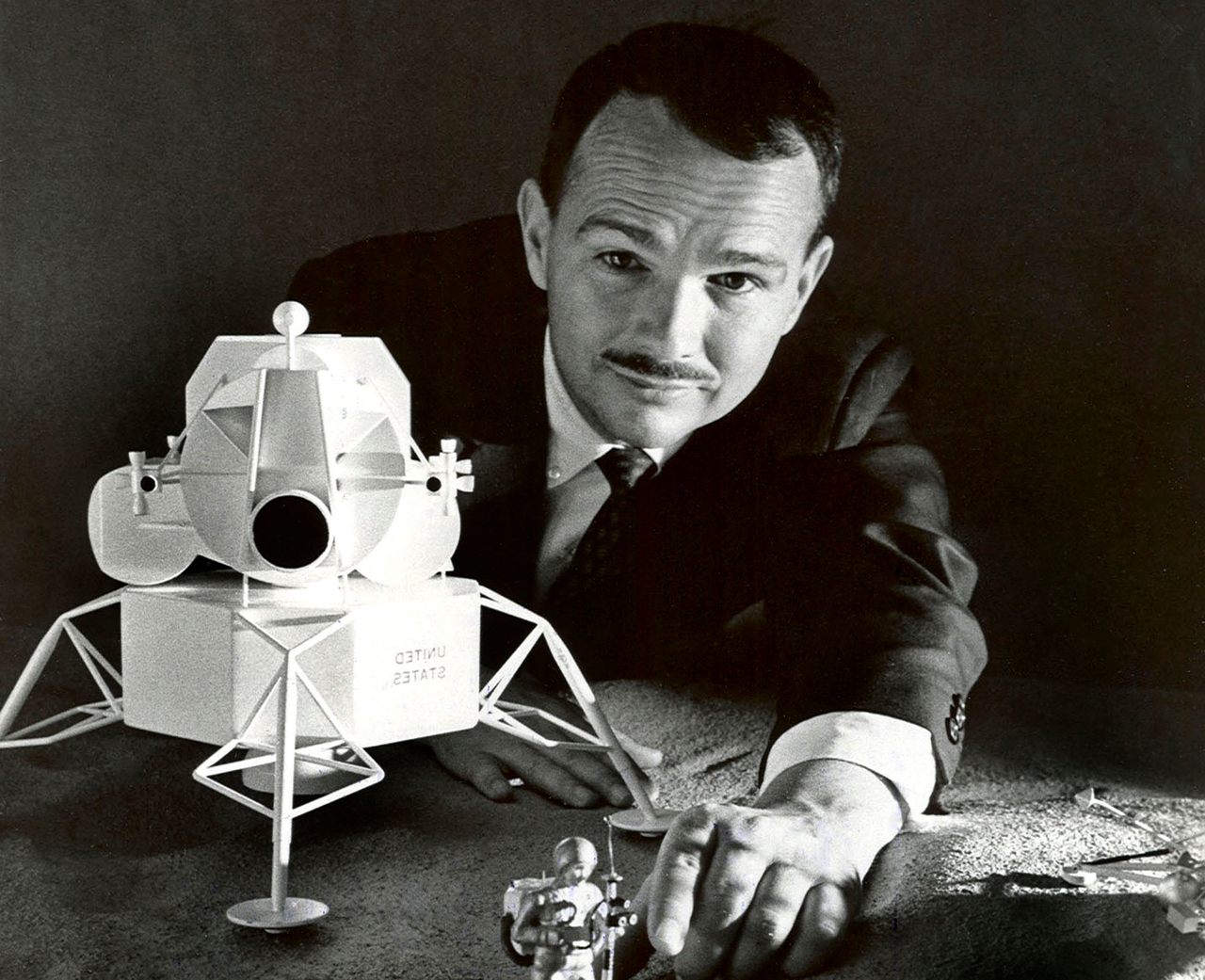 Eugene Shoemaker looking over a lunar lander model of his own making.