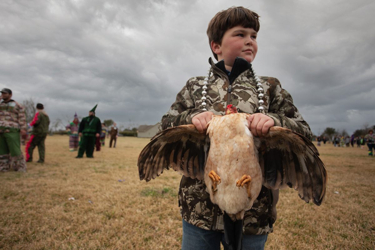 A future reveler clutches a chicken.