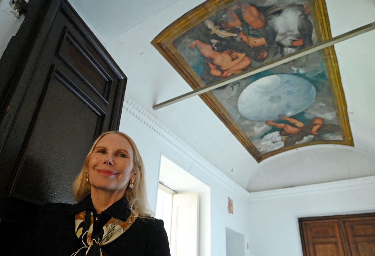 American-born princess Rita Boncompagni Ludovisi, photographed in 2022 with an unusual ceiling painting by 17th-century artist Caravaggio.