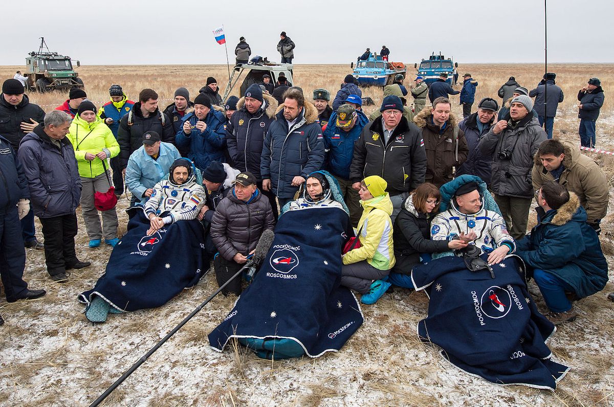 From left, Kornienko, cosmonaut Sergey Volkov, and Kelly rest in chairs outside the Soyuz TMA-18M spacecraft just minutes after landing near the town of Zhezkazgan, Kazakhstan, March 2, 2016.