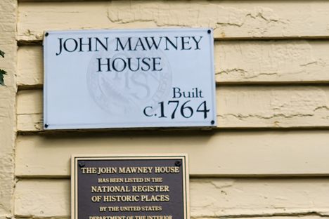 Placard on the south facing wall, near the stairs.