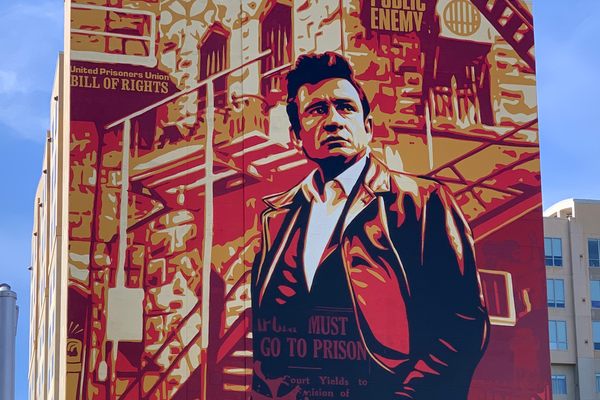 Johnny Cash rises 15 stories over a drinking establishment.