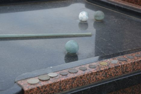 Coins lined up, reserving the place in line for a game of pool 