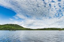 People paddling in their wooden canoes on one of the lakes near the Allagash Waterway in the north woods in Maine