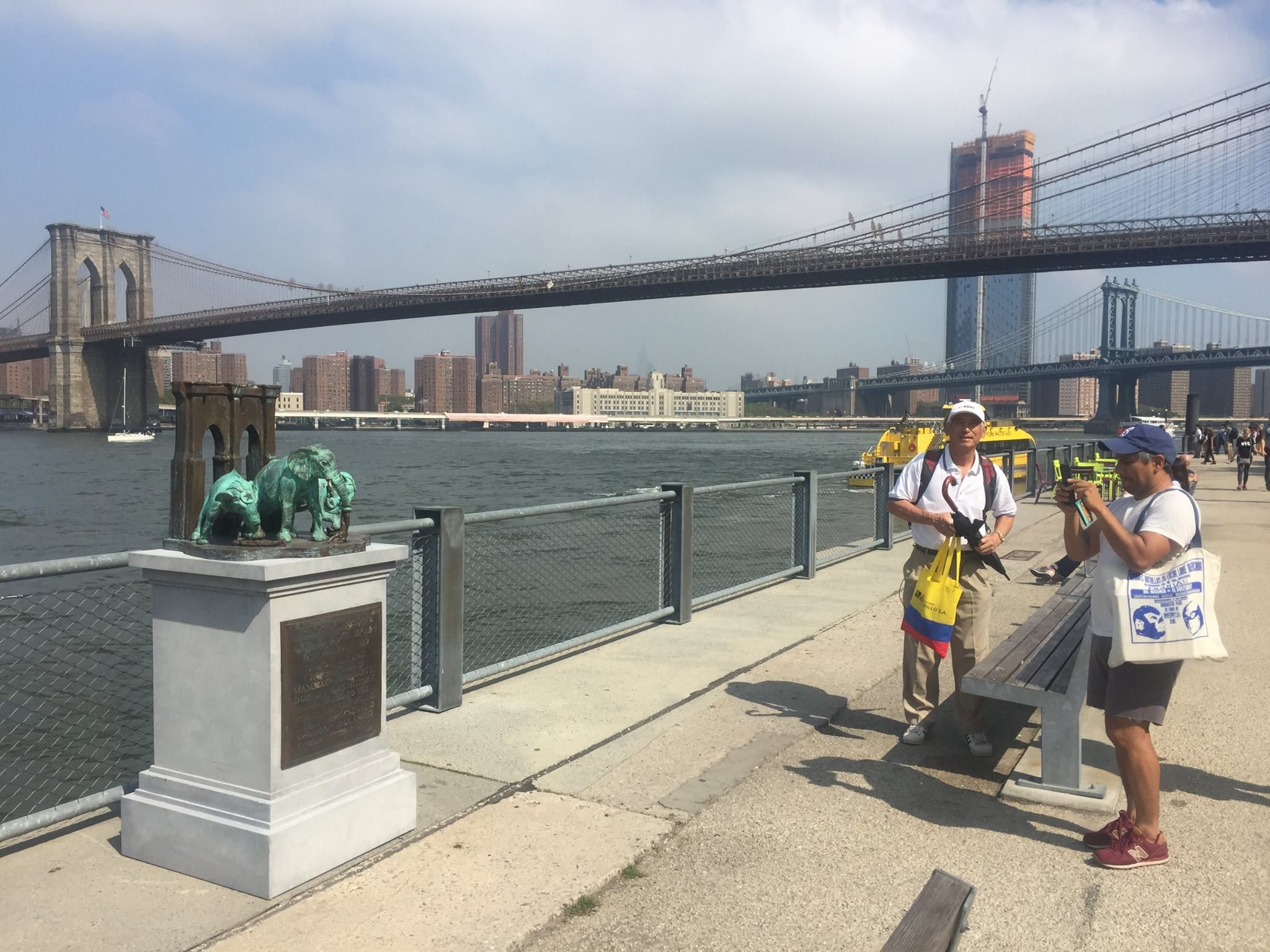 Visitors take in the Elephant Stampede Memorial in Brooklyn Bridge Park.