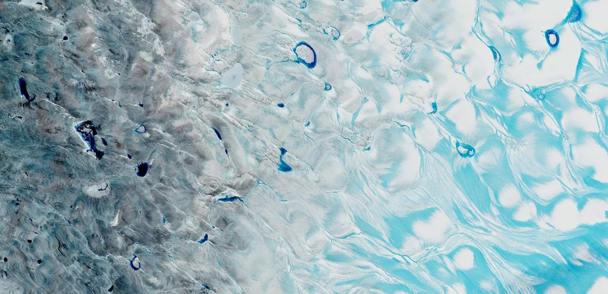 In a satellite image of the Greenland Ice Sheet's southwestern corner, captured on August 21, 2021, pale blue meltwater streams across ice or collects in slushy depressions. The deeper blue areas are meltwater lakes with depths up to about 30 feet.