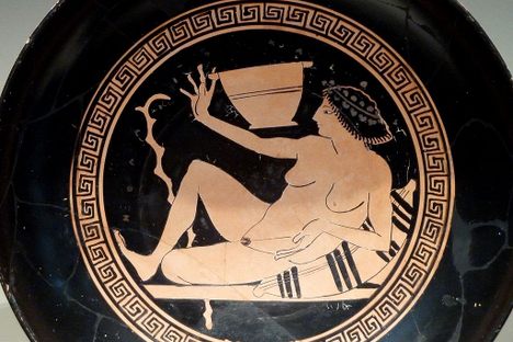A reclined player getting ready to fling some wine.