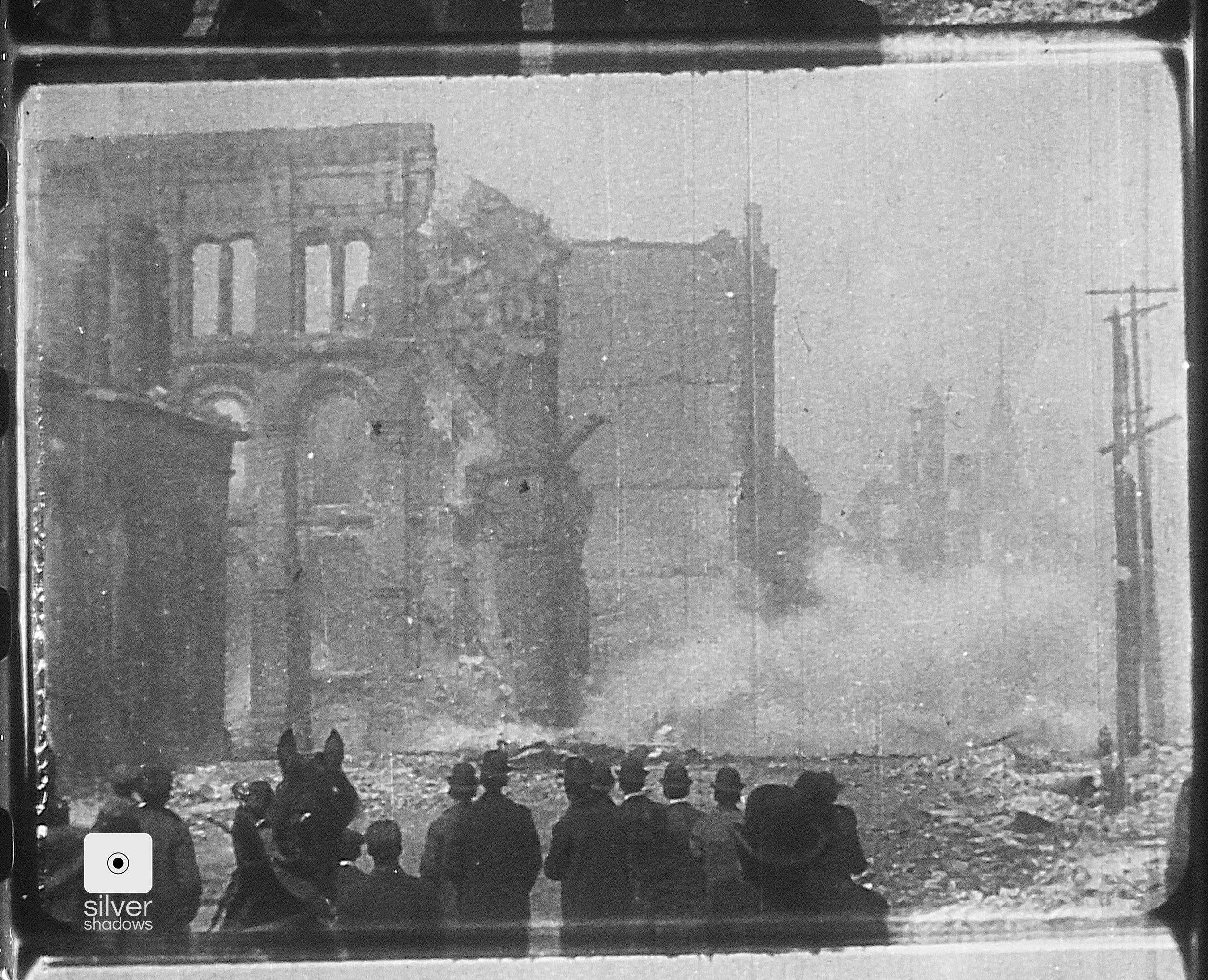 People look at the debris and wreckage left behind from the earthquake. 