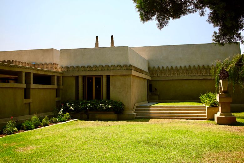 The exterior of the Hollyhock House at Barnsdall Art Park, featuring Mayan Revival architecture and a green lawn.