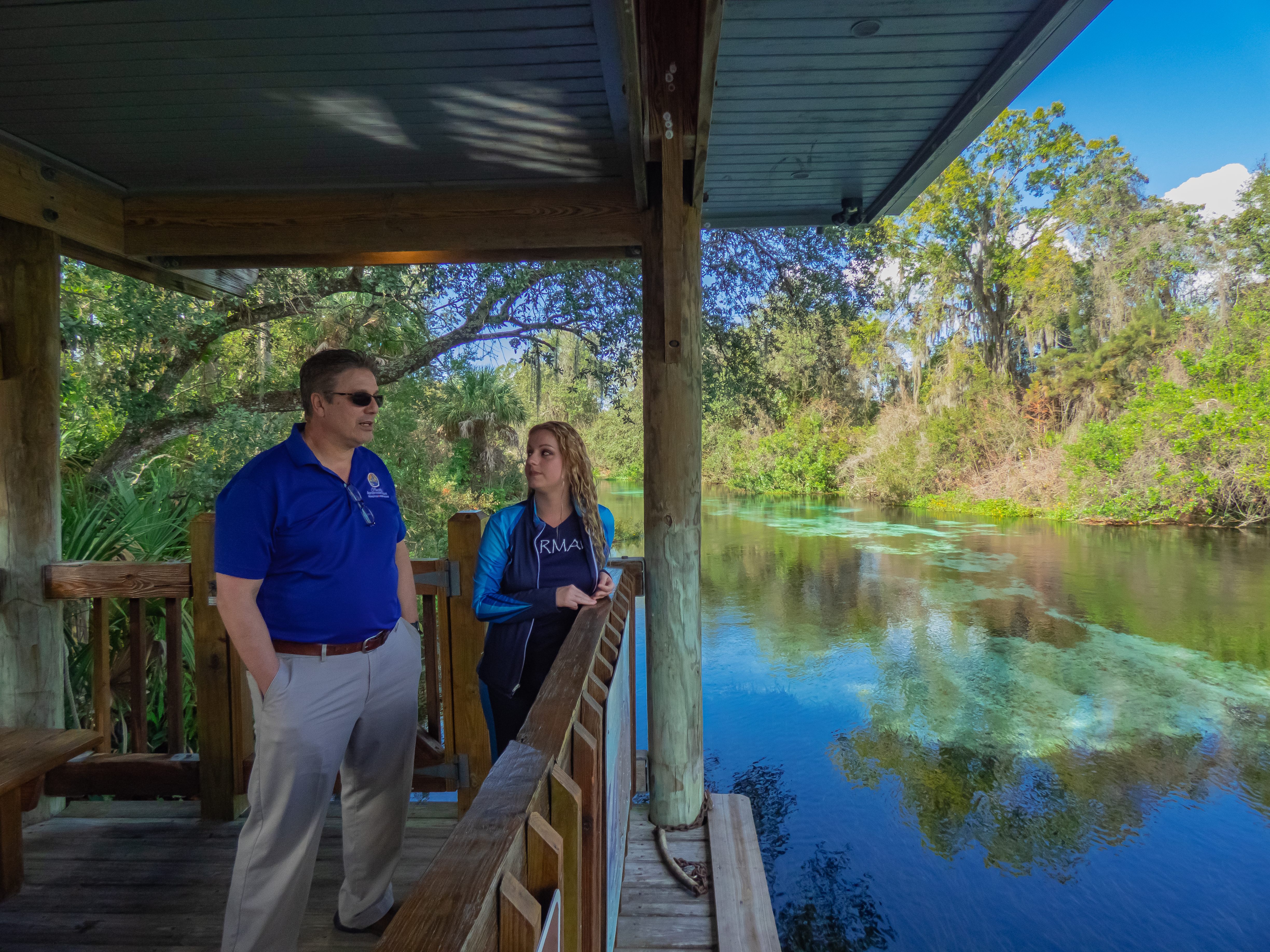 Athanason and Mermaid Lydia stand by the Weeki Wachee River, which flows seven miles into the Gulf.