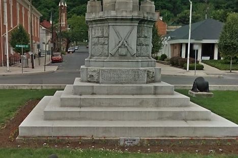 Behind the stone is a glass jar with Civil War mementos and soldiers' names