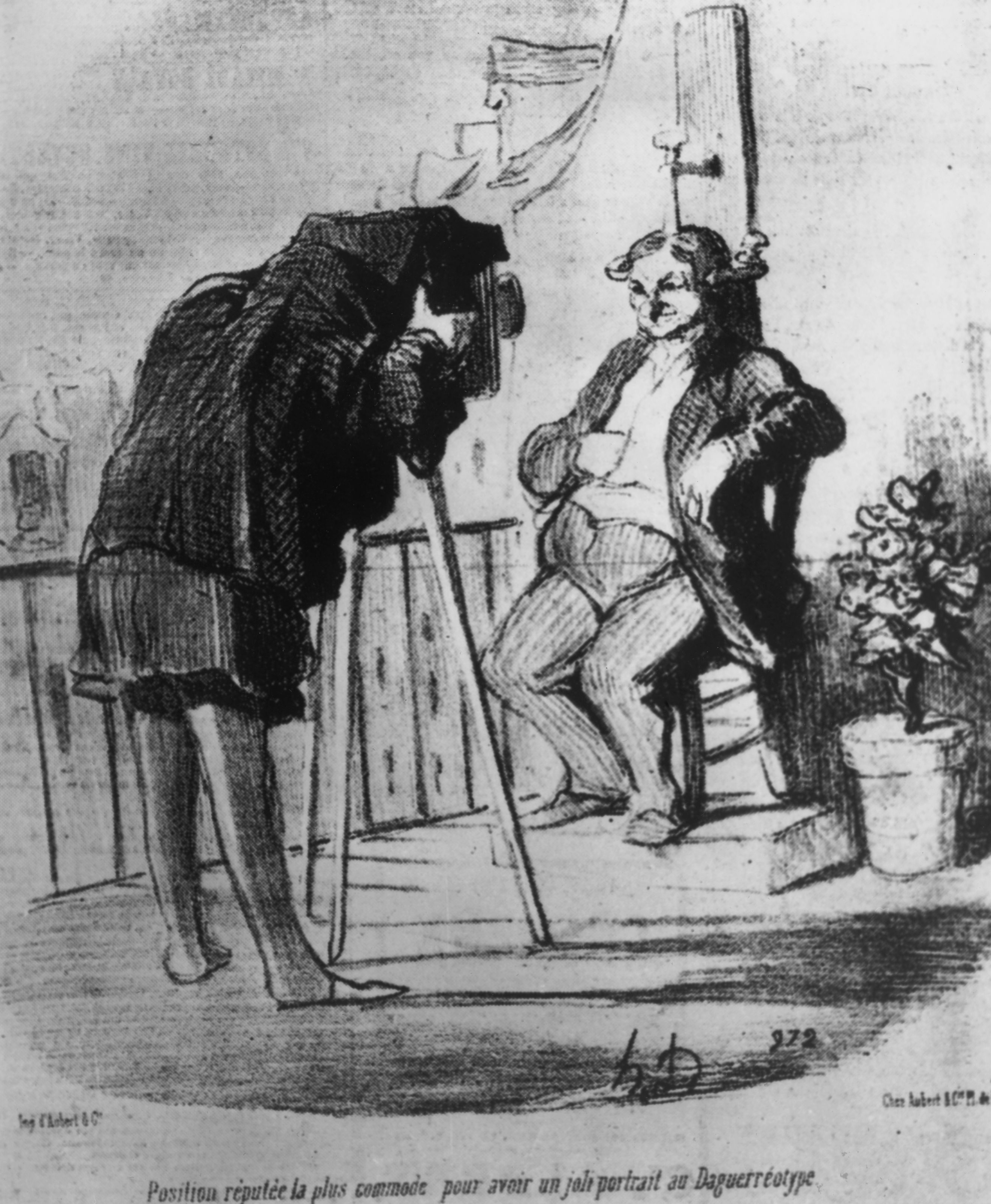 A cartoon of a man clamped to chair. The caption reads, "The Position supposed to be the most comfortable for getting a nice portrait in Daguerreotype."