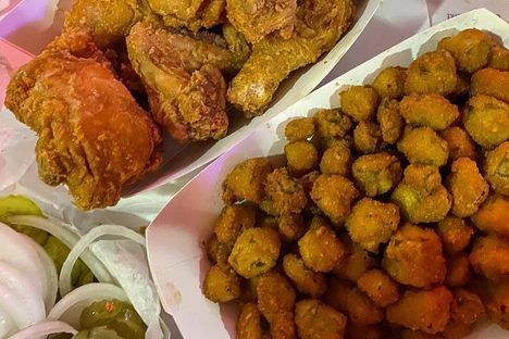 The famous fried chicken, with a side of fried okra, pickles, and onions.