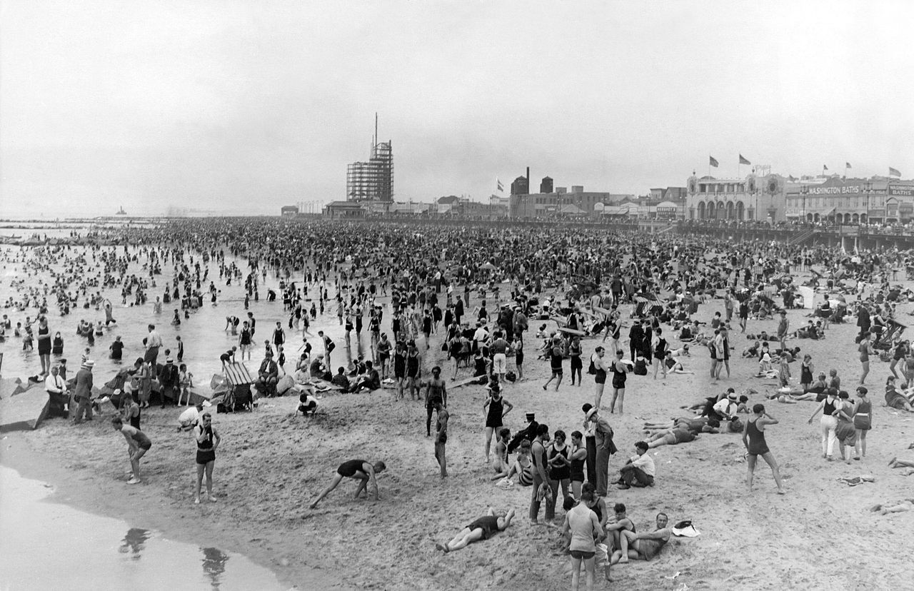 The beach at Coney Island, with the Washington Baths peeking out in the distance.