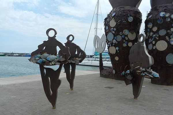 Three fishermen, with partial views of the mermaid in the back.