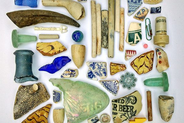Pieces of ceramic and glass that Atherton has found in the Thames, interspersed with more recent trash.