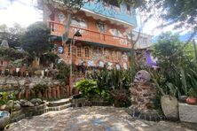 Ñaño house with mausoleum skull in foreground.