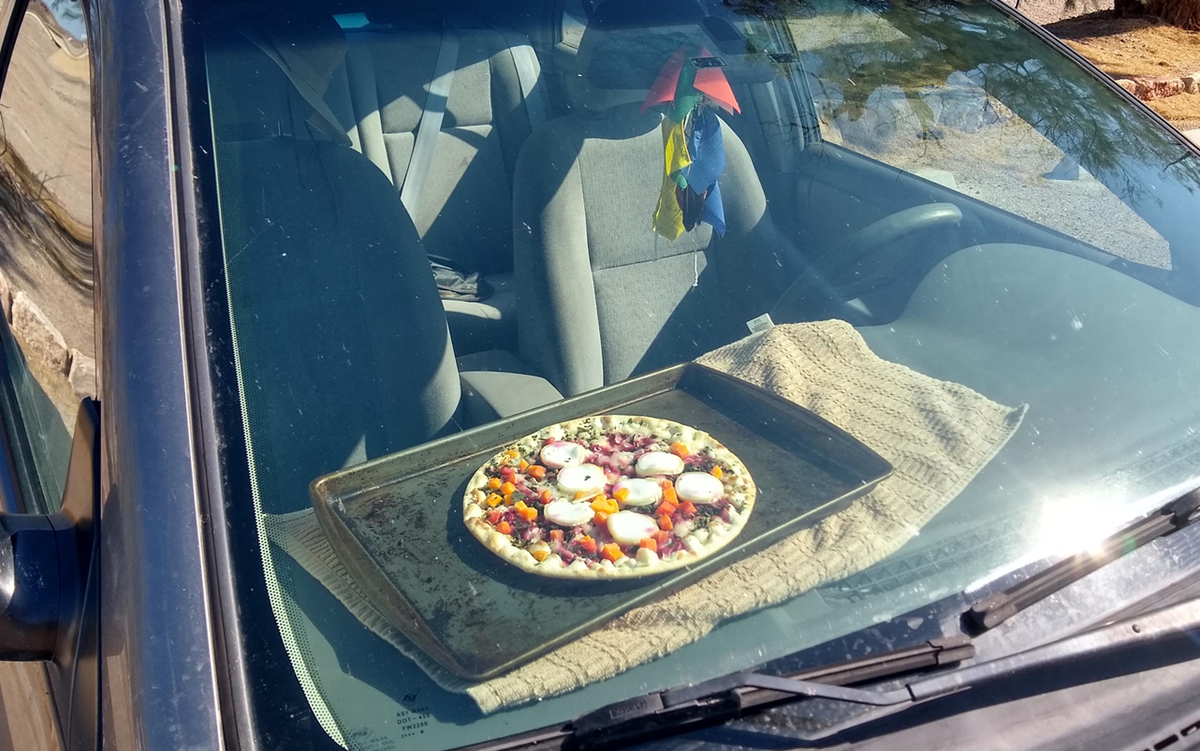 A pizza cooks on the dashboard of a car at Death Valley National Park. In the summer, temperatures routinely reach the 120s.