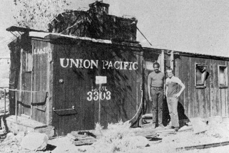 Alfred Parkinson and Fred Schoonmaker stand outside an old Union Pacific Railroad caboose, which they used temporarily using as their home (from the Bohemian Bugle, November 1986).