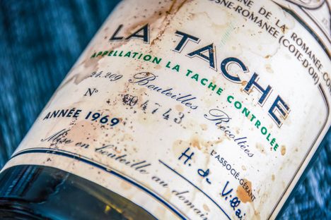 A slightly stained bottle of a 1969 Domaine de la Romanée-Conti La Tache.