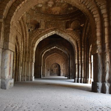 Walk through the archways of the mosque.