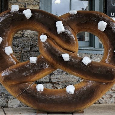 Pose with a giant pretzel outside the landmark bakery.