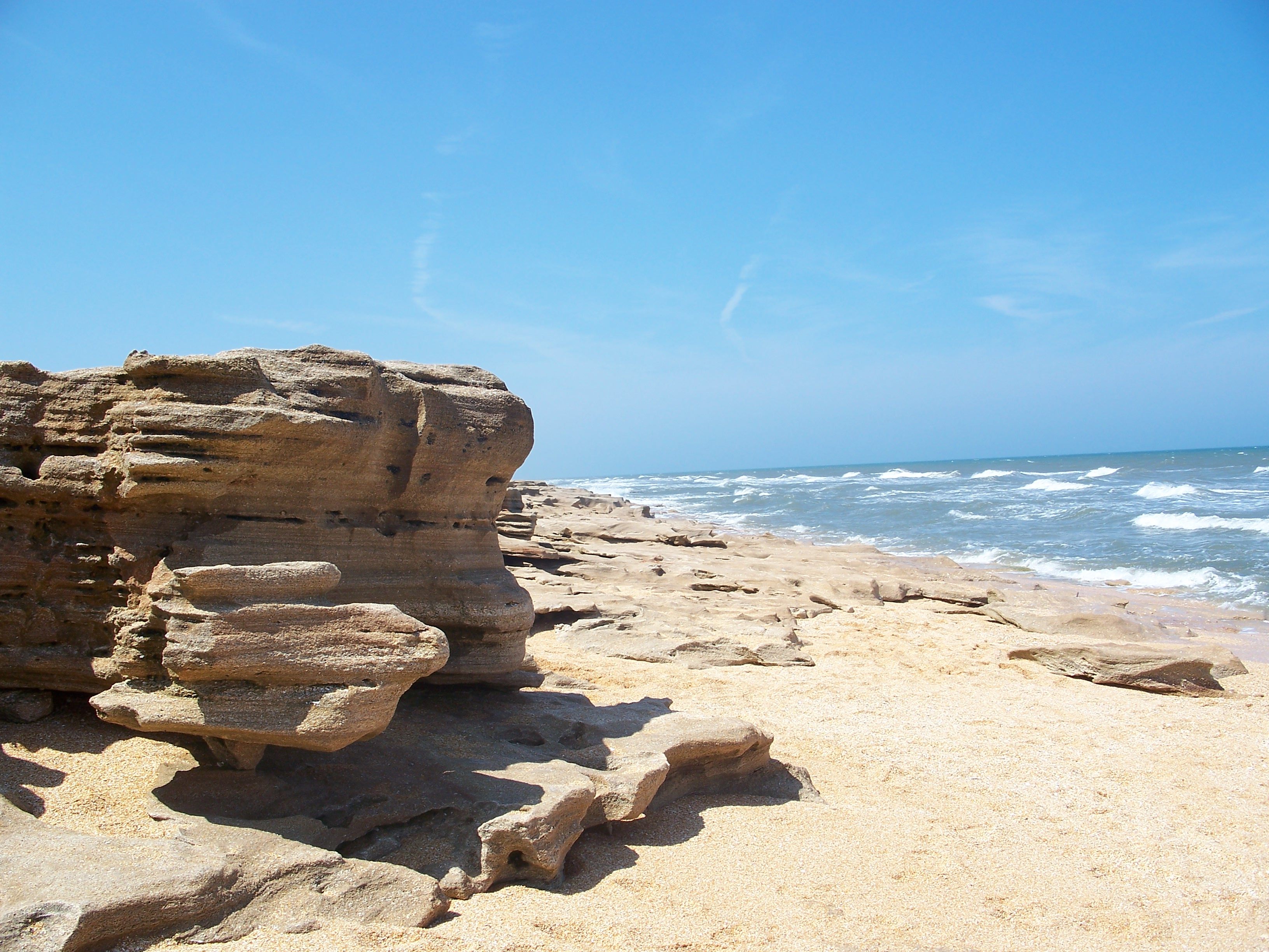 Coquina rocks in the sand at "The Rocks" beach in Florida