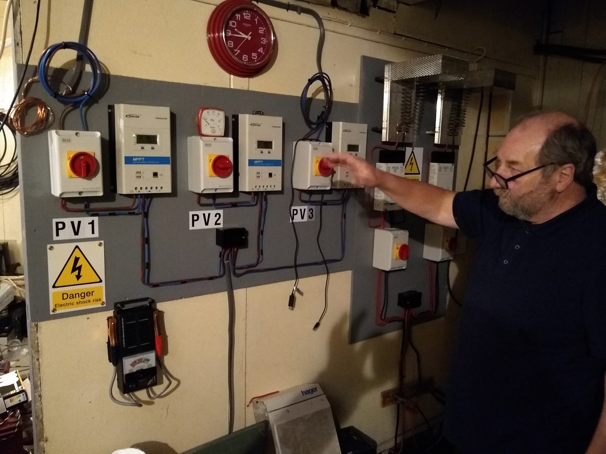 Caretaker Mike Barrington shows off the platform's power grid. Sealand is outfitted with solar and wind technology, as well as old backup diesel generators.