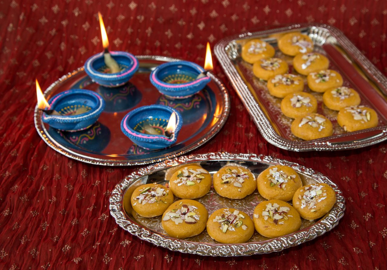 Lamps (<em>diya</em>) and sweets like these <em>peda</em> are an essential part of Diwali celebrations.